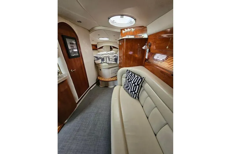 Slide: The Image of Interior of 2004 Four Winns 378 Vista yacht, featuring elegant seating and wood accents. - 27