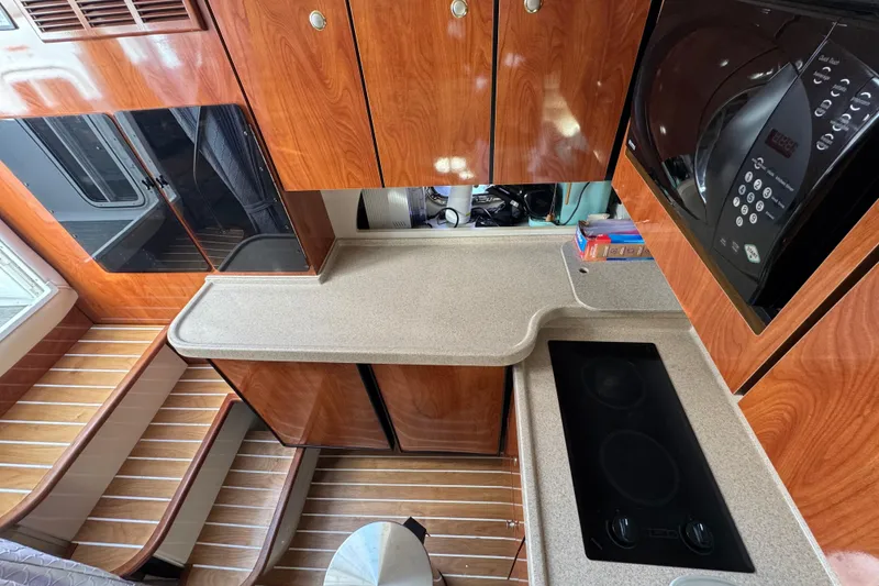 Slide: The Image of 2004 Four Winns 378 Vista yacht kitchen with wood cabinets and modern appliances. - 8