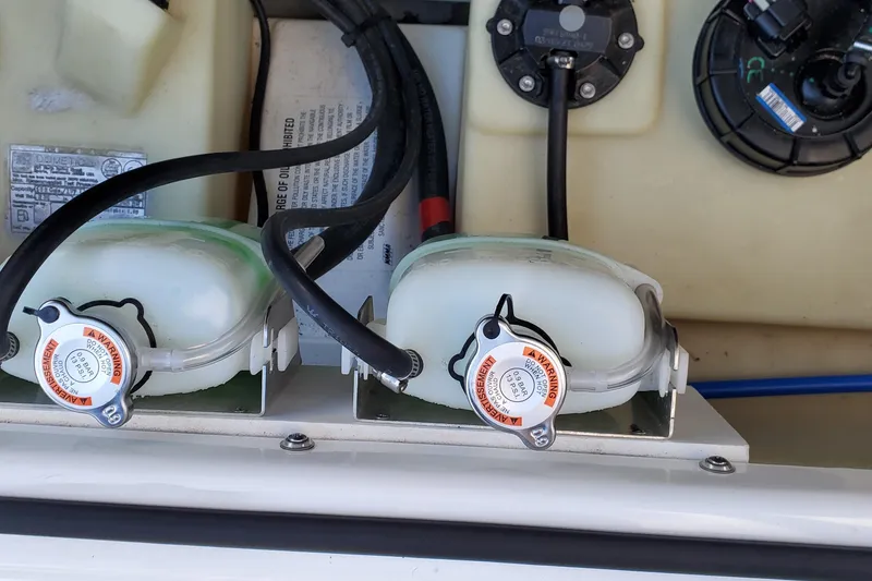 Slide: The Image of 2024 Scarab 285 Wake ID engine compartment with coolant reservoirs and wiring. - 12