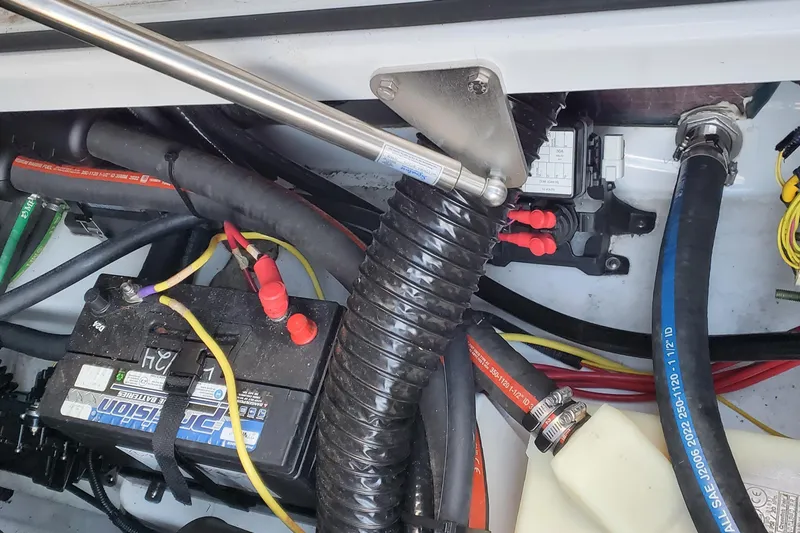 Slide: The Image of 2024 Scarab 285 Wake ID engine compartment with battery, cables, and hydraulic components. - 14