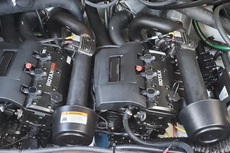 Slide: The Image of Twin Rotax engines in 2024 Scarab 285 Wake ID boat, showcasing powerful marine performance. - 16