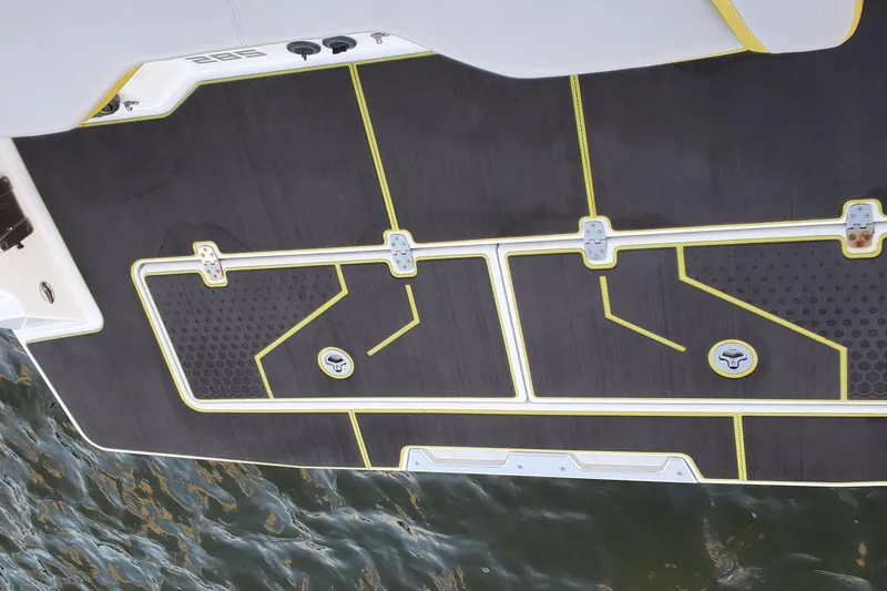 Slide: The Image of 2024 Scarab 285 Wake ID boat deck with sleek design and yellow accents. - 2