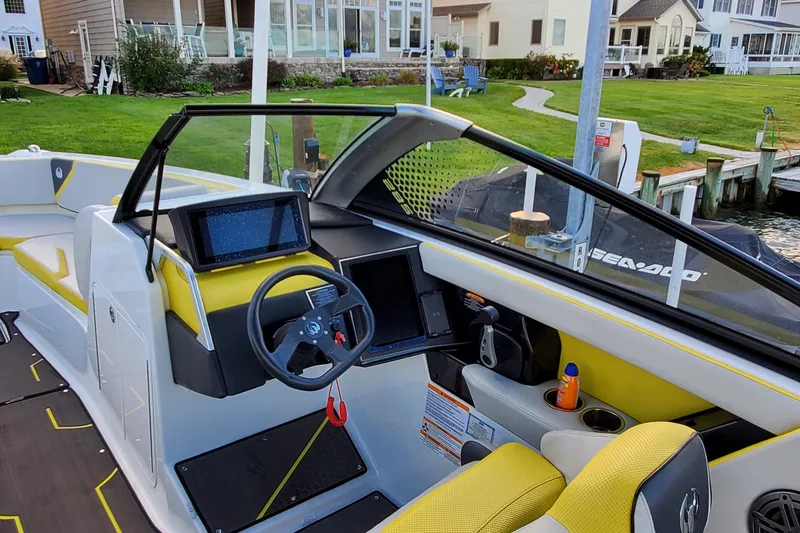 Slide: The Image of 2024 Scarab 285 Wake ID boat interior with modern dashboard and steering wheel. - 25