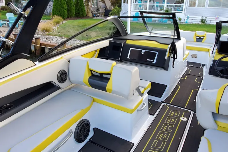 Slide: The Image of 2024 Scarab 285 Wake ID boat interior with yellow accents and modern seating. - 26