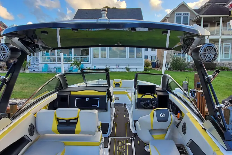 Slide: The Image of 2024 Scarab 285 Wake ID boat interior with modern design and vibrant yellow accents. - 28