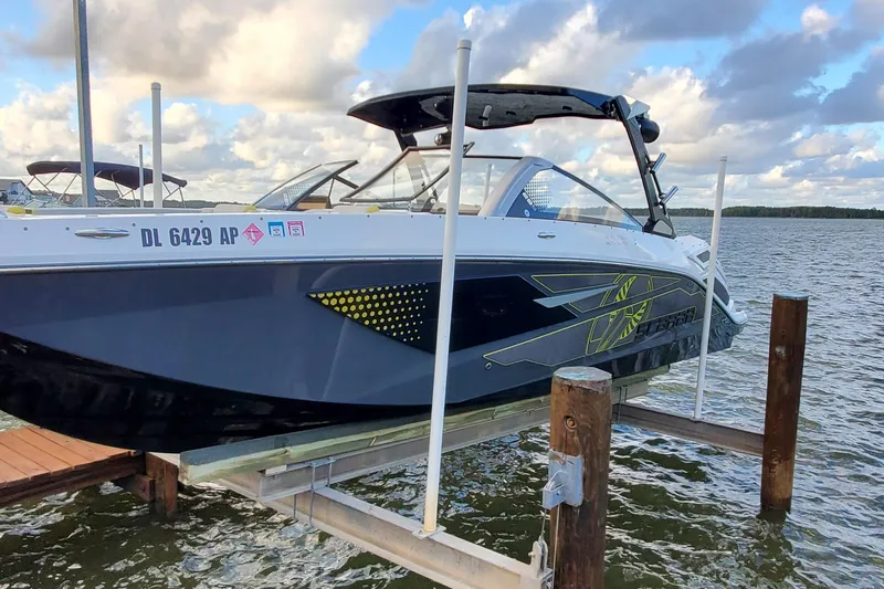 Slide: The Image of 2024 Scarab 285 Wake ID boat docked on a lift by the water. - 35