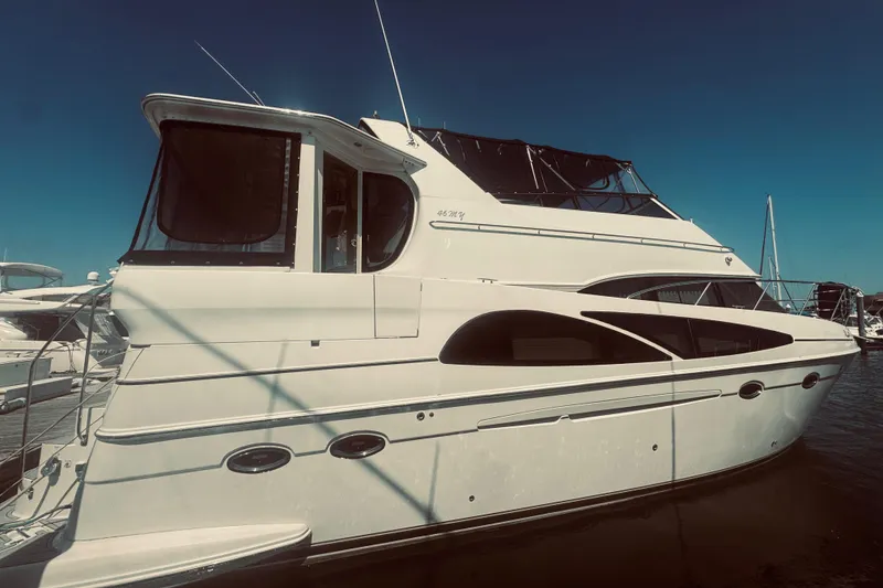 The Image of 2005 Carver 466 Motor Yacht docked at marina under clear blue sky. - 0