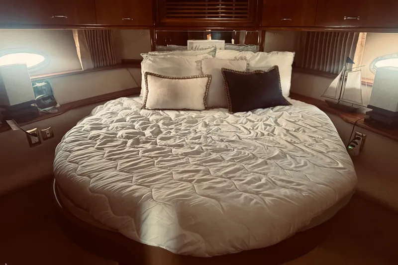 Slide: The Image of Luxurious bedroom interior of 2005 Carver 466 Motor Yacht with plush bedding and elegant decor. - 12