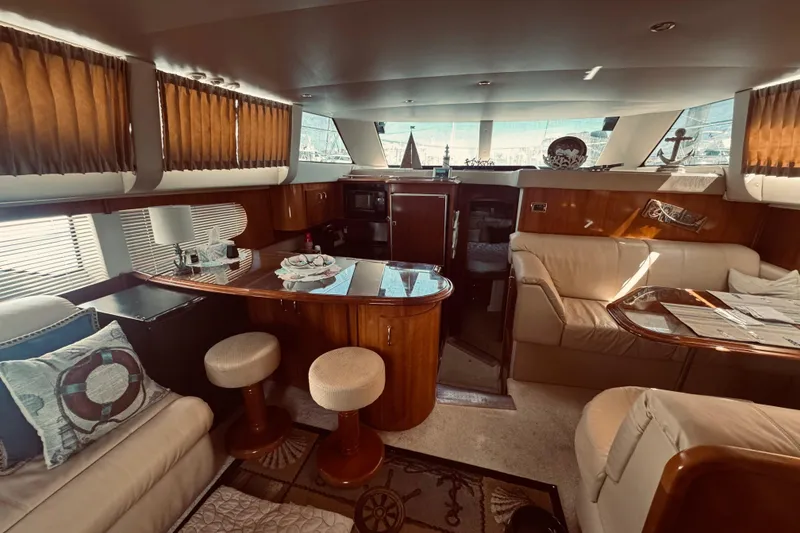 Slide: The Image of Luxurious interior of 2005 Carver 466 Motor Yacht with elegant seating and wooden finishes. - 16