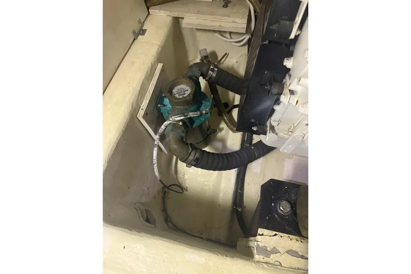 Slide: The Image of Engine compartment of 2005 Carver 466 Motor Yacht, featuring hoses and mechanical components. - 28