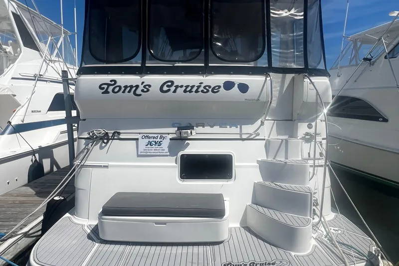Slide: The Image of 2005 Carver 466 Motor Yacht docked, featuring "Tom's Cruise" signage and curved steps. - 3