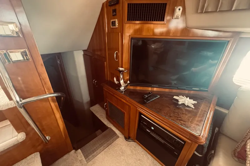 Slide: The Image of Interior of 2005 Carver 466 Motor Yacht with TV and wooden cabinetry. - 15