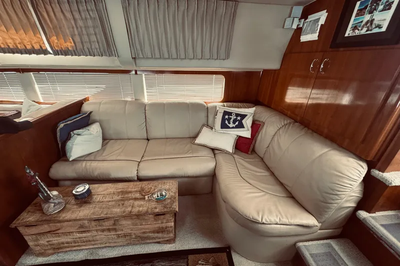 Slide: The Image of Luxurious interior of 2005 Carver 466 Motor Yacht with beige leather sofa and nautical decor. - 19