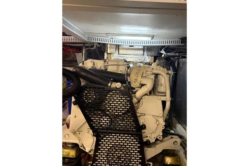 Slide: The Image of Engine room of 2005 Carver 466 Motor Yacht, showcasing mechanical components and wiring. - 26