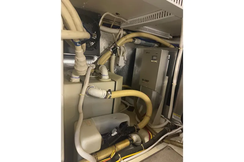 Slide: The Image of Engine room of 2005 Carver 466 Motor Yacht with hoses and electrical components. - 29