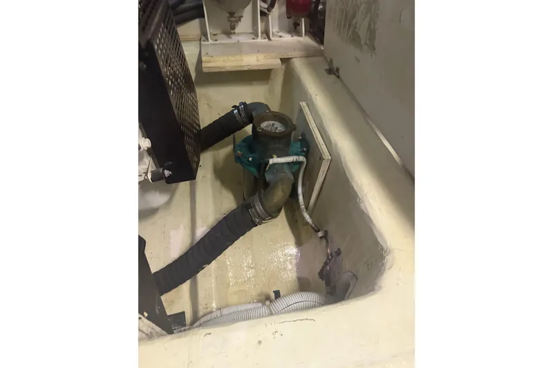 Slide: The Image of Engine compartment of 2005 Carver 466 Motor Yacht showing hoses and mechanical components. - 30