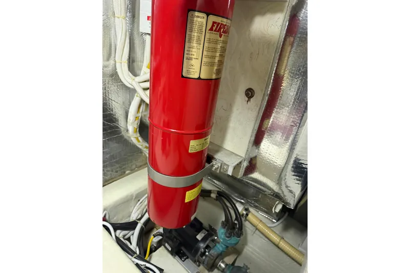Slide: The Image of Engine room of 2005 Carver 466 Motor Yacht with fire extinguisher and wiring. - 32