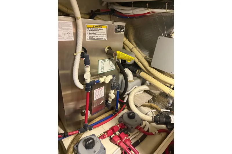 Slide: The Image of Engine room of 2005 Carver 466 Motor Yacht with various pipes and equipment. - 33