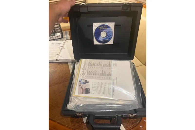 Slide: The Image of Open case with Carver 466 Motor Yacht documents and CD, 2005 model. - 35