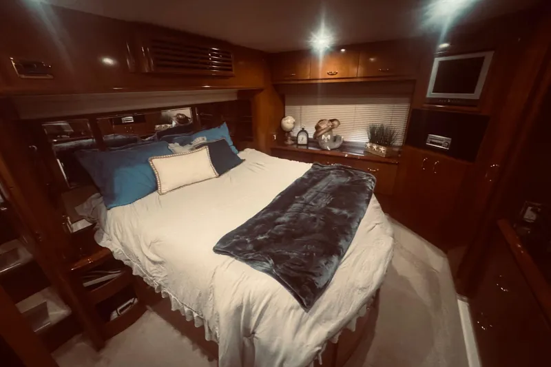 Slide: The Image of Luxurious bedroom interior of 2005 Carver 466 Motor Yacht with cozy bedding and elegant decor. - 37