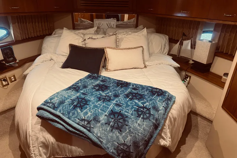 Slide: The Image of Luxurious bedroom interior of 2005 Carver 466 Motor Yacht with nautical-themed decor. - 38