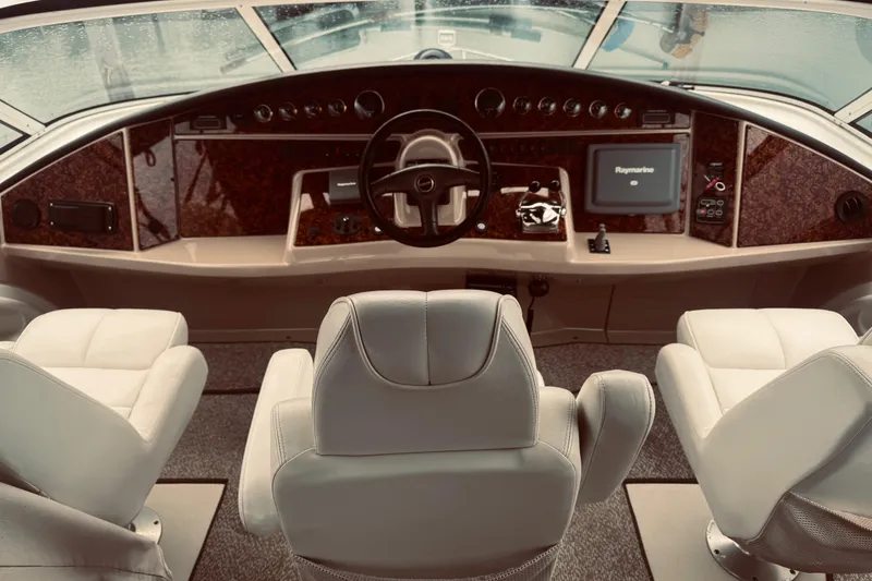 Slide: The Image of 2005 Carver 466 Motor Yacht helm with leather seats and navigation equipment. - 40