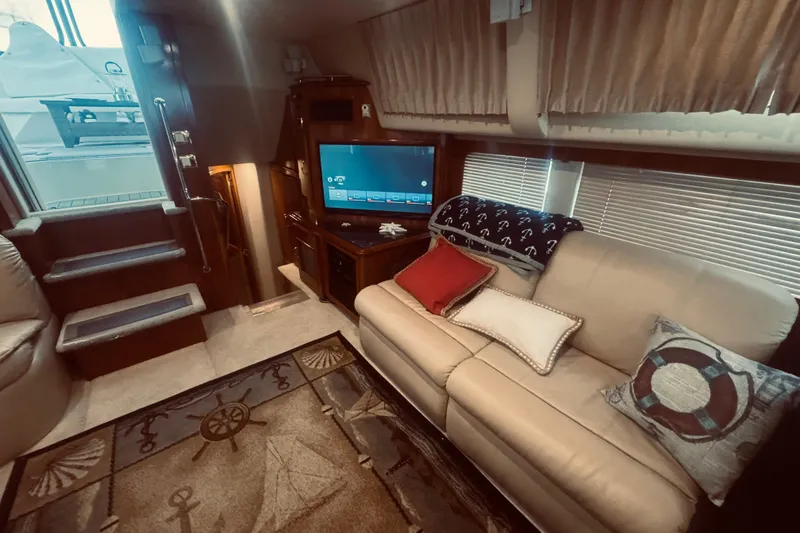 Slide: The Image of Luxurious interior of 2005 Carver 466 Motor Yacht with cozy seating and nautical decor. - 41