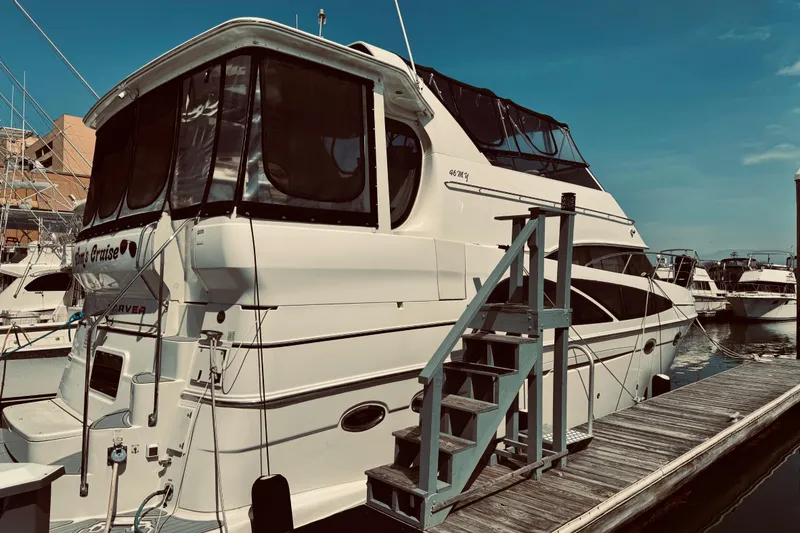 Slide: The Image of 2005 Carver 466 Motor Yacht docked at marina under clear blue sky. - 45