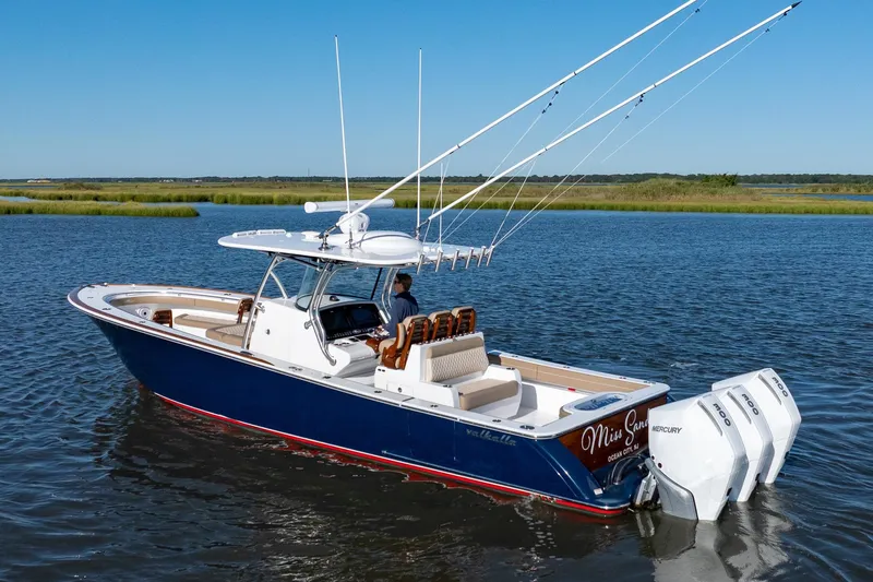 Slide: The Image of 2023 Valhalla Boatworks V-37 cruising on a serene lake with fishing rods. - 1