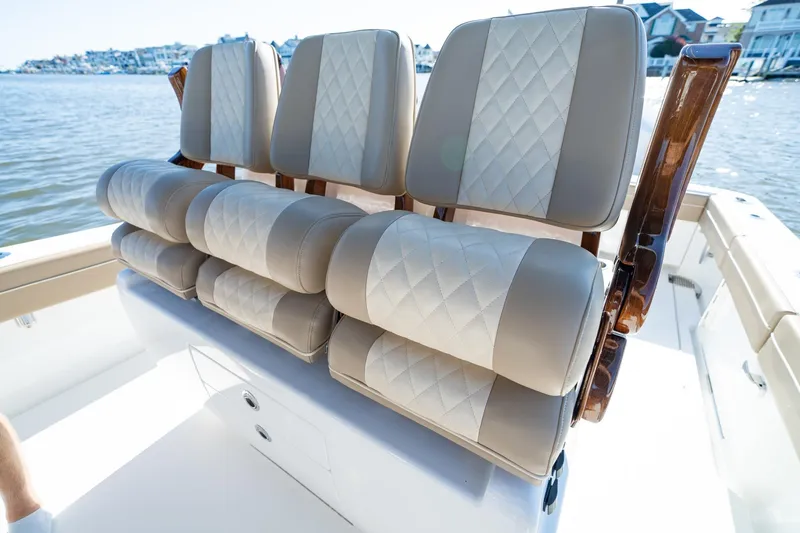 Slide: The Image of 2023 Valhalla Boatworks V-37 seating with luxurious diamond-stitched upholstery on a sunny day. - 16