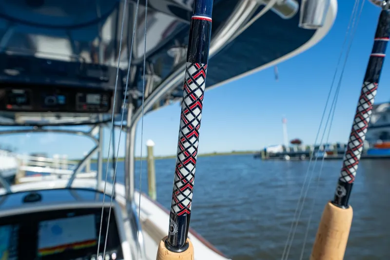 Slide: The Image of 2023 Valhalla Boatworks V-37 with fishing rods, docked by the water. - 25
