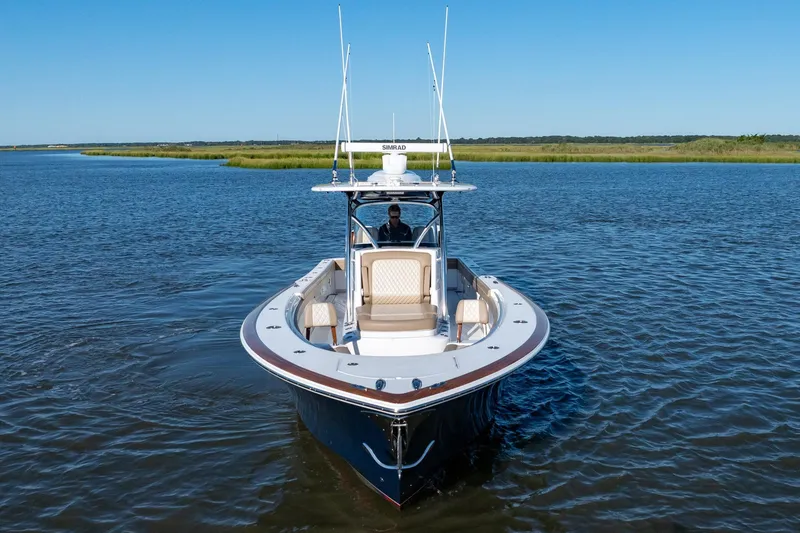 Slide: The Image of 2023 Valhalla Boatworks V-37 cruising on calm waters under a clear blue sky. - 6