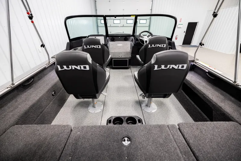 Slide: The Image of 2026 Lund 2075 Impact XS boat interior with four branded seats in a spacious layout. - 12