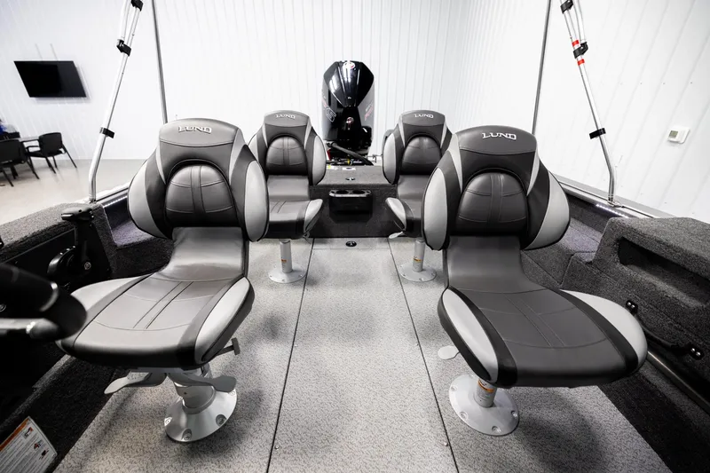 Slide: The Image of 2026 Lund 2075 Impact XS boat interior with four gray seats and modern design. - 16
