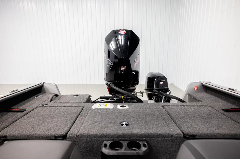 Slide: The Image of 2026 Lund 2075 Impact XS boat interior with motor, gray carpeted deck. - 20