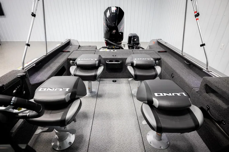 Slide: The Image of 2026 Lund 2075 Impact XS boat interior with four seats and motor. - 21