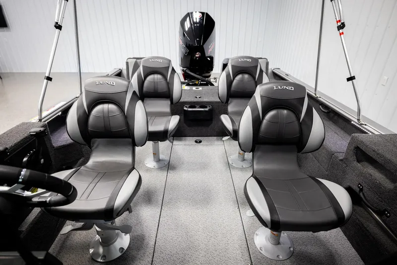 Slide: The Image of 2026 Lund 2075 Impact XS boat interior with four black and gray seats. - 22