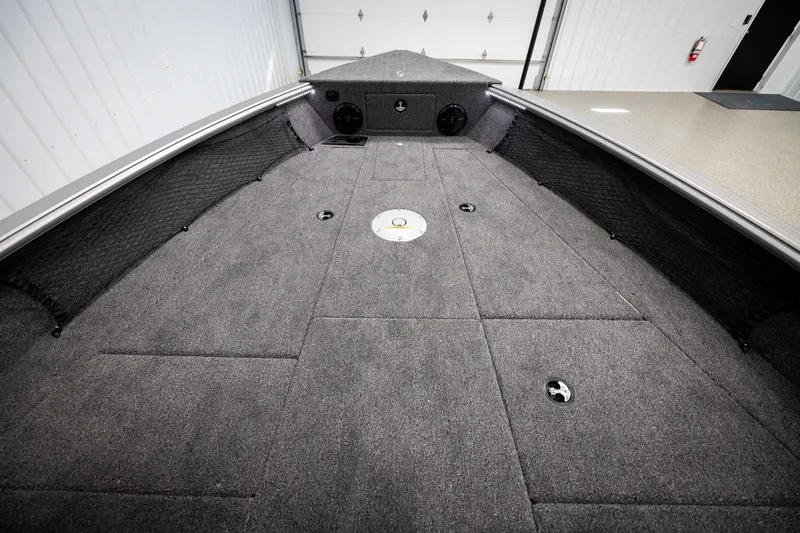 Slide: The Image of 2026 Lund 2075 Impact XS boat interior with spacious carpeted deck. - 23