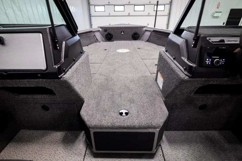 Slide: The Image of 2026 Lund 2075 Impact XS boat interior with spacious deck and modern controls. - 25