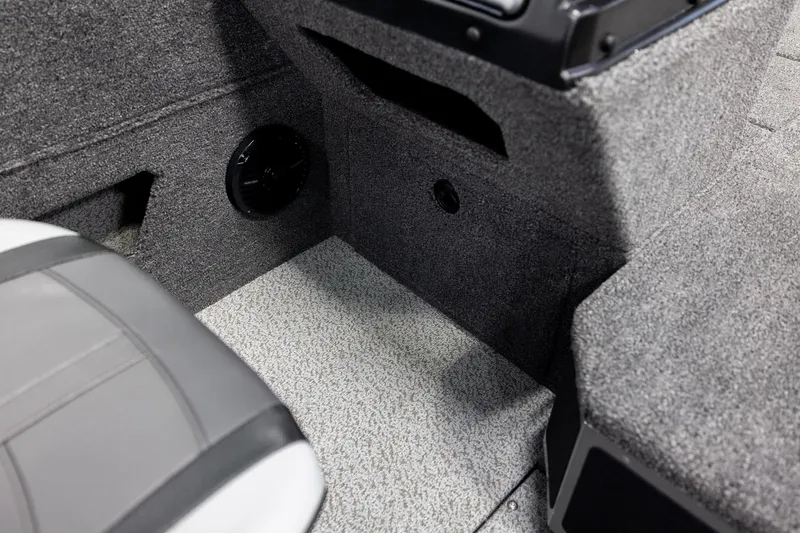 Slide: The Image of Interior of 2026 Lund 2075 Impact XS boat, featuring carpeted flooring and seating. - 27