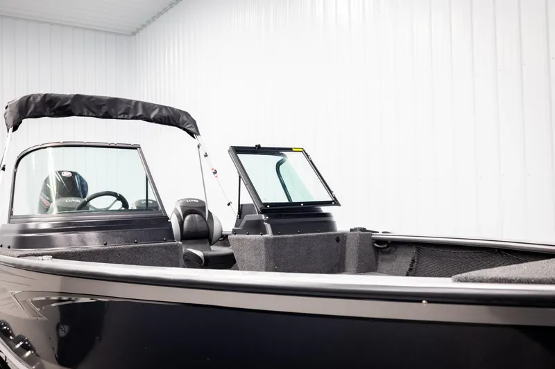 Slide: The Image of 2026 Lund 2075 Impact XS boat in showroom, featuring sleek design and spacious interior. - 31