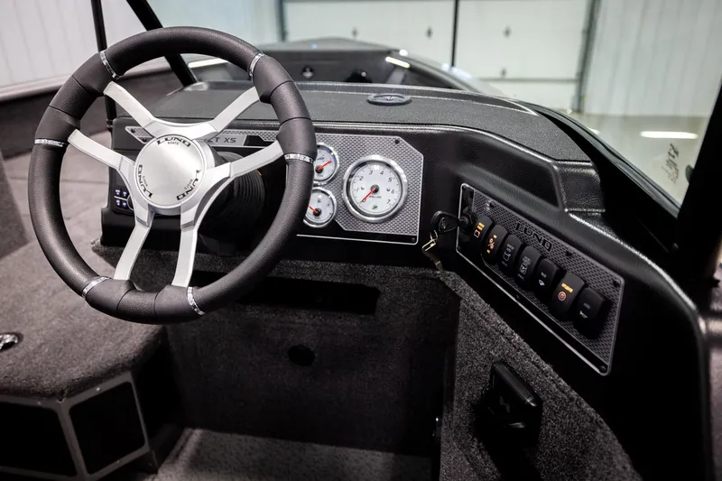 Slide: The Image of 2026 Lund 2075 Impact XS boat dashboard with steering wheel and control panel. - 33