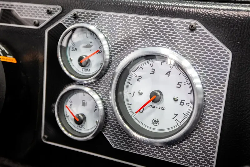 Slide: The Image of Dashboard gauges of 2026 Lund 2075 Impact XS boat, featuring RPM, trim, and fuel indicators. - 37