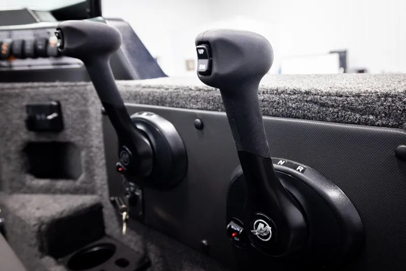 Slide: The Image of 2026 Lund 2075 Impact XS boat controls with dual throttle levers. - 40