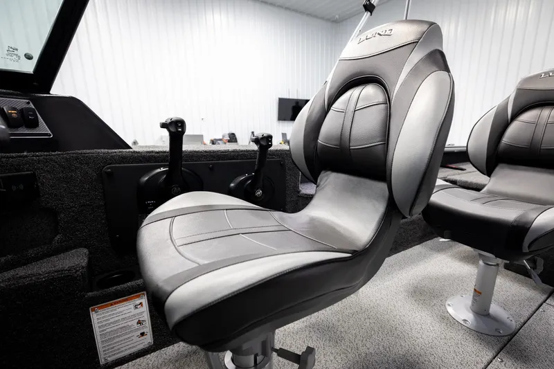 Slide: The Image of 2026 Lund 2075 Impact XS boat interior with modern seating and controls. - 41