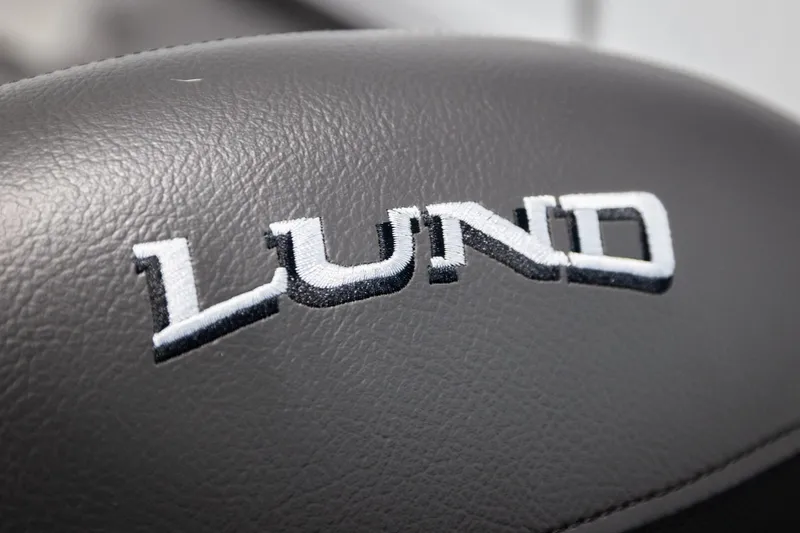 Slide: The Image of Close-up of Lund logo on 2026 Lund 2075 Impact XS boat seat. - 42