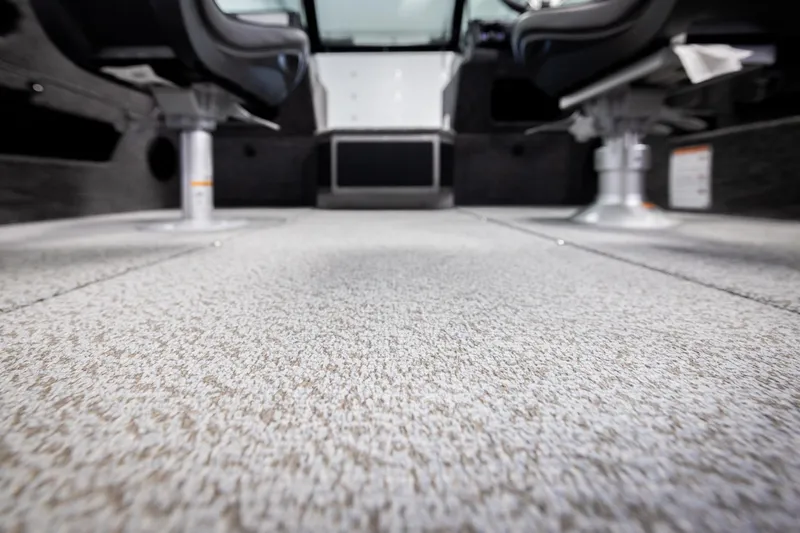 Slide: The Image of Interior view of 2026 Lund 2075 Impact XS boat, featuring textured flooring and seating. - 48