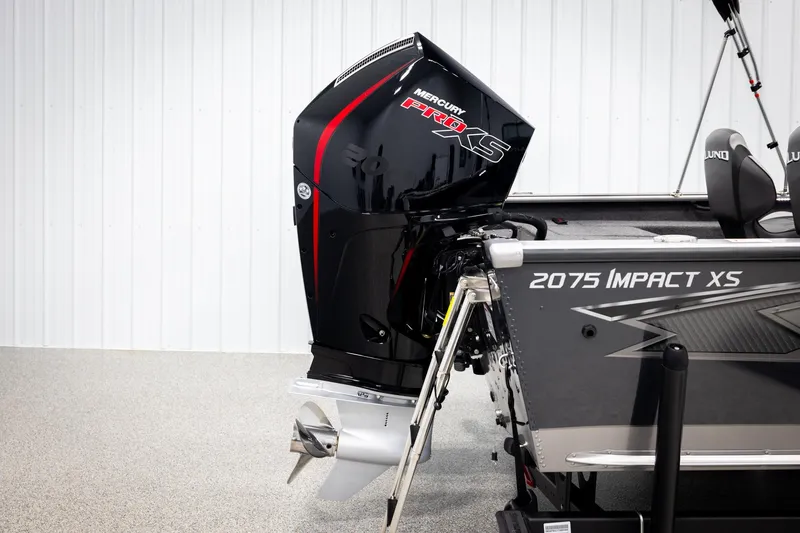 Slide: The Image of 2026 Lund 2075 Impact XS boat with Mercury Pro XS engine in a showroom. - 49