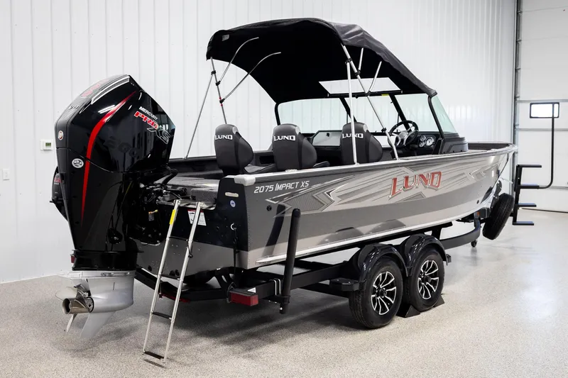 Slide: The Image of 2026 Lund 2075 Impact XS boat with Mercury Pro XS engine in showroom. - 5