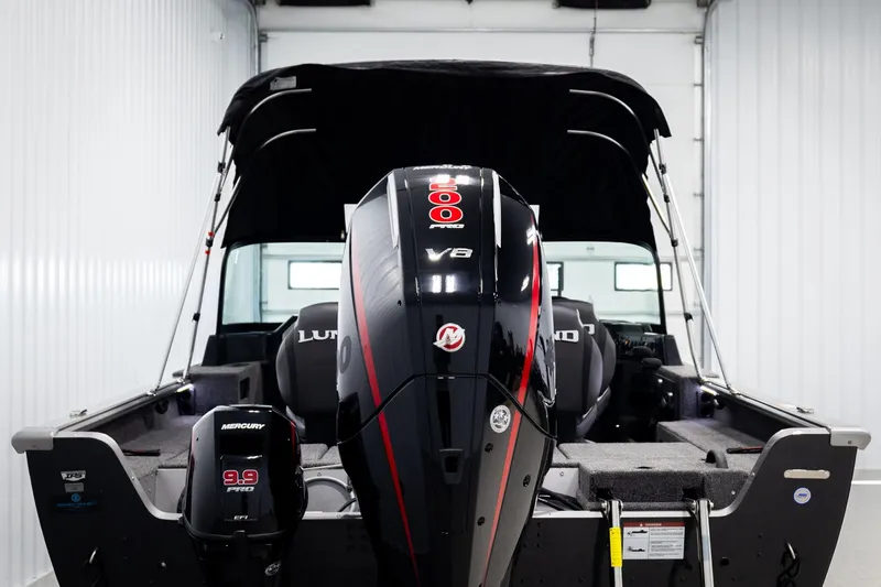 Slide: The Image of 2026 Lund 2075 Impact XS boat with powerful Mercury V8 engine in a garage. - 6